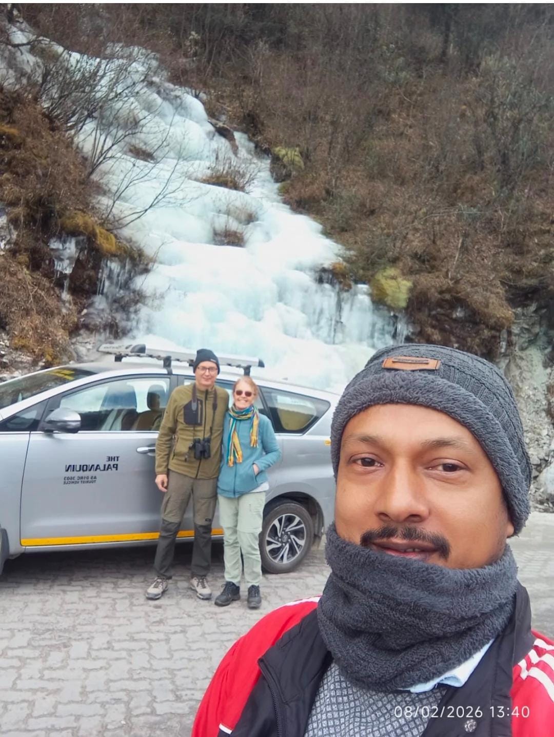 PalanQuin driver and guests at frozen waterfall, Arunachal Pradesh